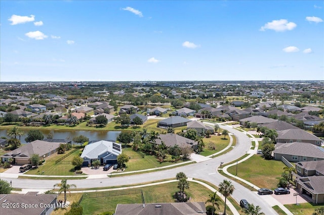 drone / aerial view featuring a water view and a residential view