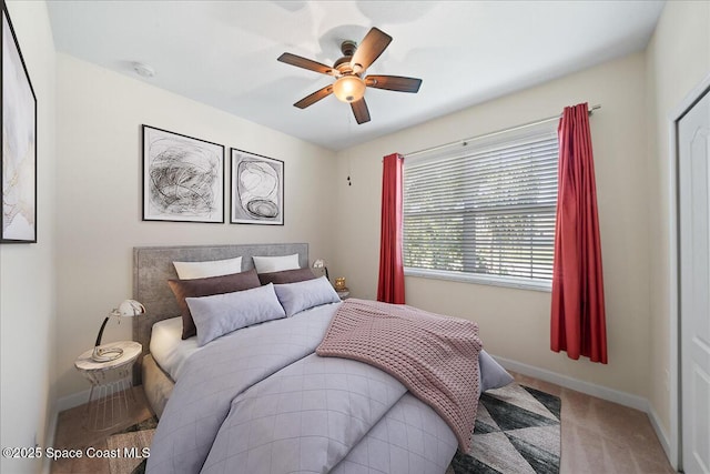 bedroom with baseboards, carpet flooring, and a ceiling fan