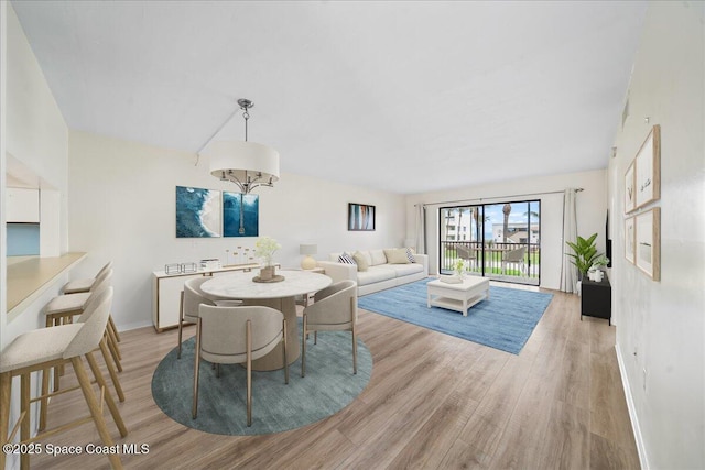 1950 Atlantic St Unit 223, Melbourne Beach, FL 32951 - dining area with light wood-style flooring and baseboards