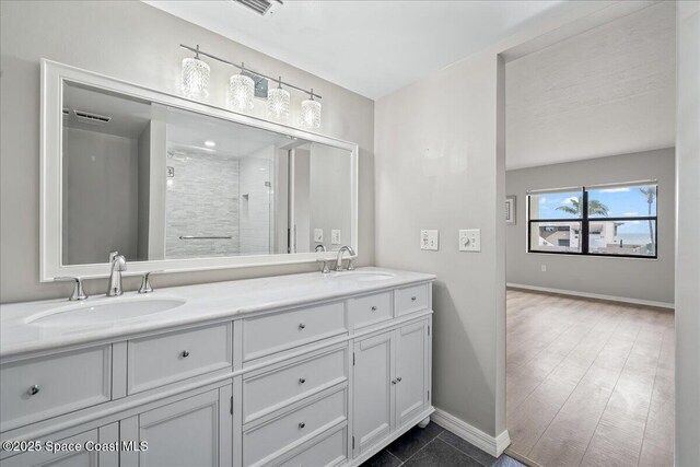1950 Atlantic St Unit 223, Melbourne Beach, FL 32951 - full bath with double vanity, baseboards, and a shower stall