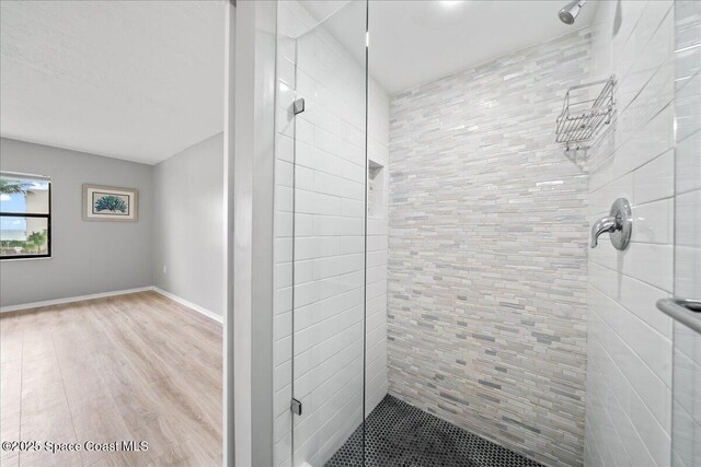 1950 Atlantic St Unit 223, Melbourne Beach, FL 32951 - bathroom with a stall shower, wood finished floors, and baseboards