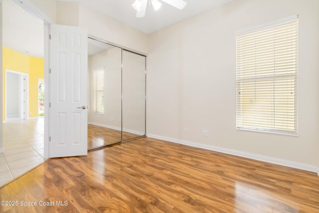 3547 Plume Way, Palm Bay, FL 32909 - unfurnished bedroom featuring a closet, wood finished floors, and baseboards