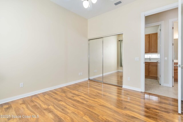 3547 Plume Way, Palm Bay, FL 32909 - unfurnished bedroom featuring a closet, baseboards, visible vents, a sink, and light wood-type flooring