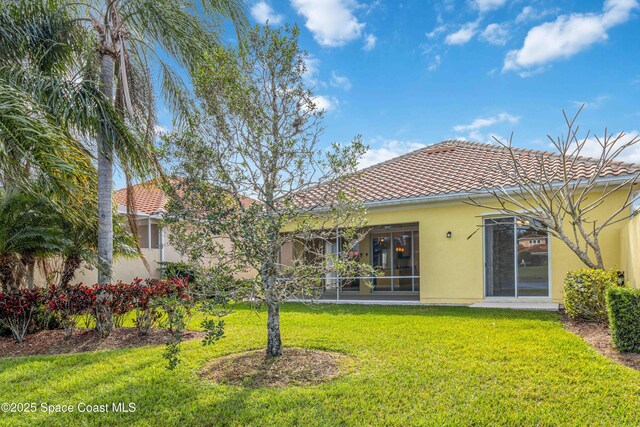 3547 Plume Way, Palm Bay, FL 32909 - rear view of house featuring a yard, stucco siding, and a tile roof