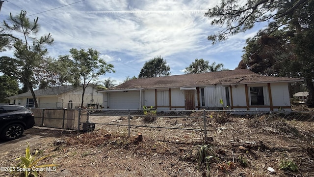 single story home with a garage and fence