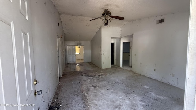 spare room with visible vents, lofted ceiling, and ceiling fan