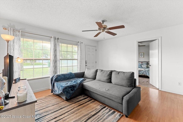 5970 Coker Ave, Cocoa, FL 32927 - living area with a ceiling fan, a textured ceiling, light wood-style floors, and baseboards