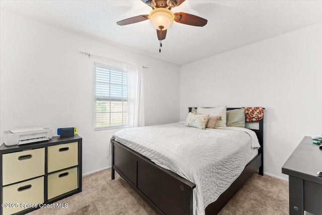 5970 Coker Ave, Cocoa, FL 32927 - bedroom with light carpet, a ceiling fan, a textured ceiling, and baseboards