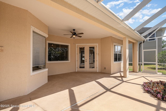 view of patio / terrace featuring french doors, a ceiling fan, and a lanai