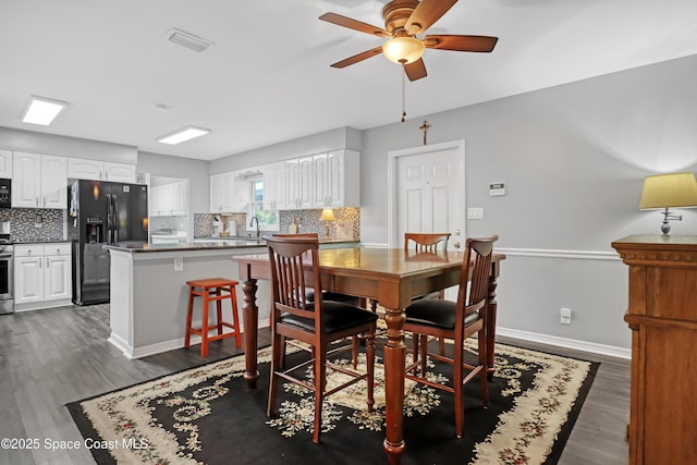 5280 Curtis Blvd, Cocoa, FL 32927 - dining space featuring ceiling fan, dark wood-style floors, and baseboards