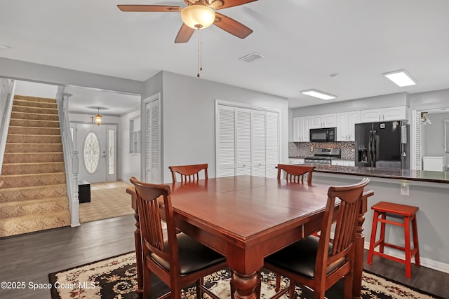 5280 Curtis Blvd, Cocoa, FL 32927 - dining area featuring wood finished floors, stairway, and a ceiling fan