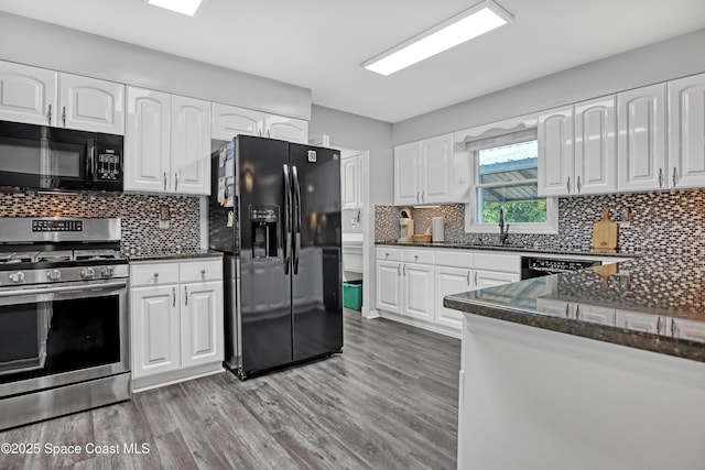 5280 Curtis Blvd, Cocoa, FL 32927 - kitchen featuring black appliances, a sink, light wood-style floors, white cabinets, and backsplash