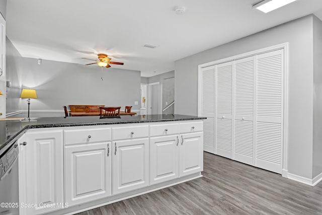 5280 Curtis Blvd, Cocoa, FL 32927 - kitchen with stainless steel dishwasher, a ceiling fan, white cabinetry, and dark stone countertops