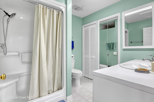 5280 Curtis Blvd, Cocoa, FL 32927 - bathroom featuring toilet, a closet, vanity, tile patterned floors, and curtained shower