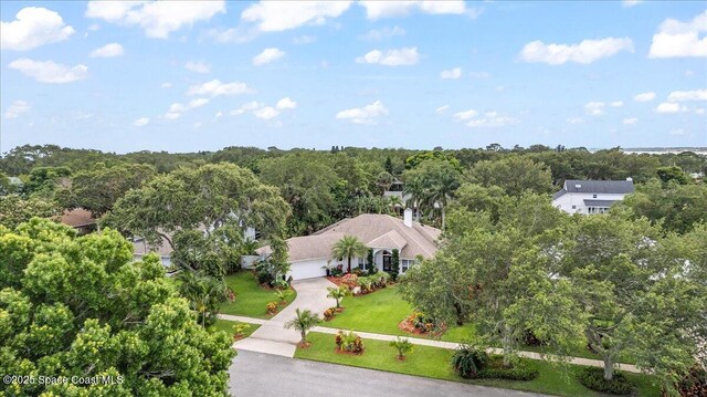 1085 Mercedes Dr, Merritt Island, FL 32952 - aerial view of property and surrounding area featuring a heavily wooded area