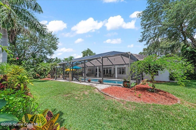 1085 Mercedes Dr, Merritt Island, FL 32952 - back of property with a yard, an outdoor pool, a patio, and glass enclosure