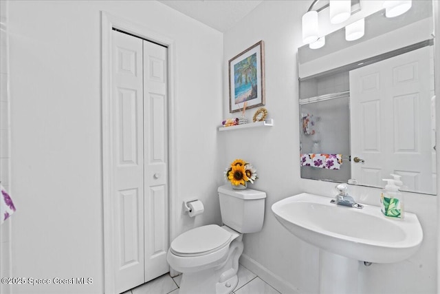 1085 Mercedes Dr, Merritt Island, FL 32952 - bathroom with a closet, toilet, a sink, baseboards, and a shower
