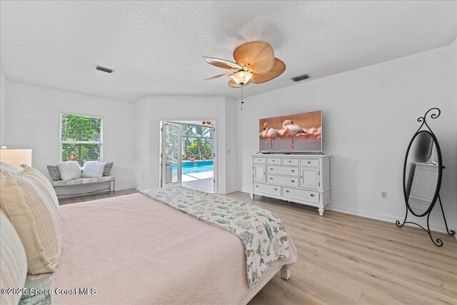 1085 Mercedes Dr, Merritt Island, FL 32952 - bedroom featuring access to exterior, light wood finished floors, a textured ceiling, ceiling fan, and baseboards