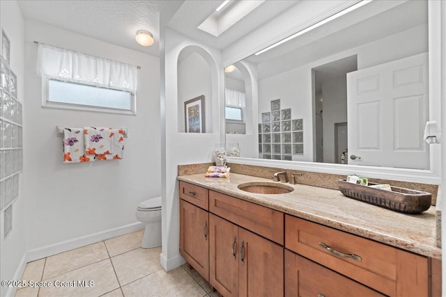 1085 Mercedes Dr, Merritt Island, FL 32952 - bathroom with tile patterned flooring, baseboards, vanity, and toilet