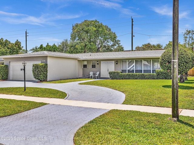 5118 Adams St, Hollywood, FL 33021 - ranch-style house featuring curved driveway, a front lawn, and a garage