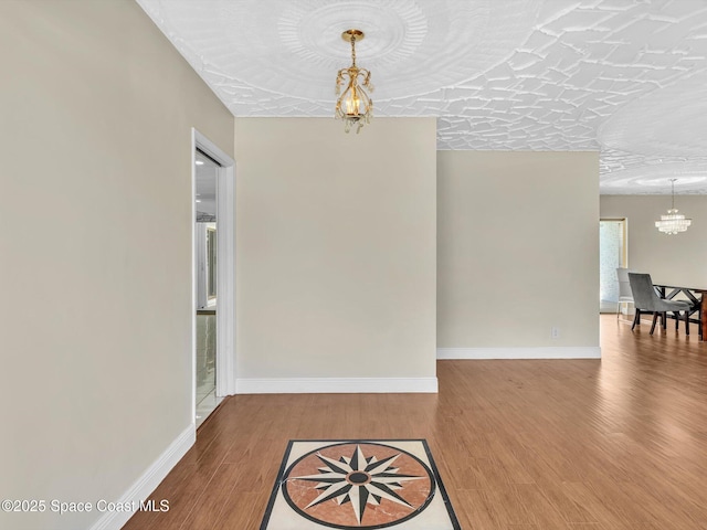 5118 Adams St, Hollywood, FL 33021 - unfurnished dining area with a chandelier, wood finished floors, and baseboards