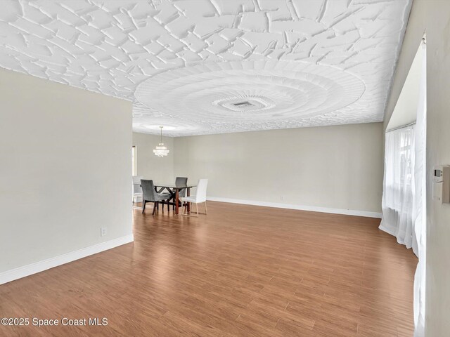 5118 Adams St, Hollywood, FL 33021 - unfurnished room featuring wood finished floors, baseboards, and a chandelier