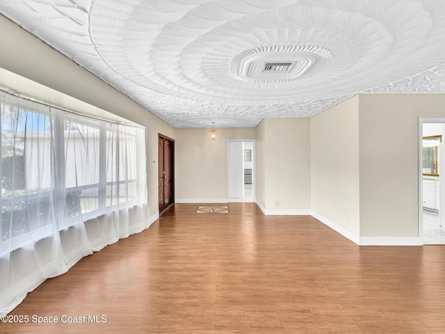 5118 Adams St, Hollywood, FL 33021 - spare room with plenty of natural light, baseboards, and wood finished floors