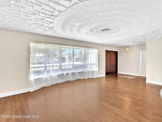 5118 Adams St, Hollywood, FL 33021 - unfurnished living room featuring healthy amount of natural light, baseboards, and wood finished floors