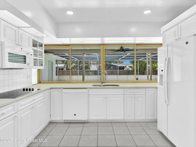 5118 Adams St, Hollywood, FL 33021 - kitchen featuring white appliances, a sink, light tile patterned floors, light countertops, and white cabinets