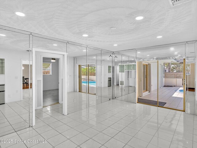 5118 Adams St, Hollywood, FL 33021 - empty room with light tile patterned flooring and recessed lighting