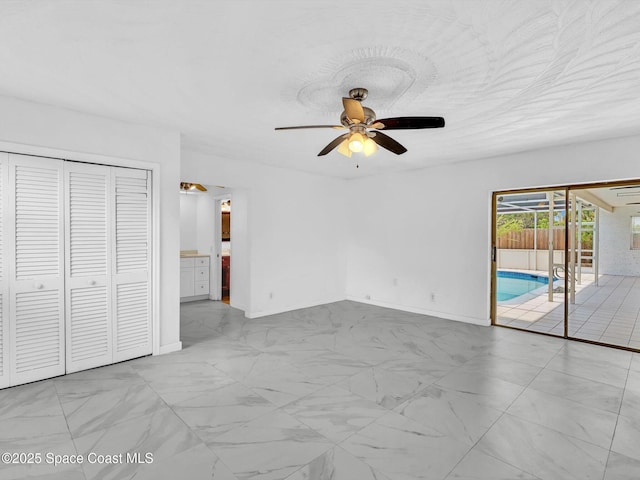 5118 Adams St, Hollywood, FL 33021 - unfurnished bedroom featuring access to exterior, marble finish floors, baseboards, ceiling fan, and ensuite bathroom