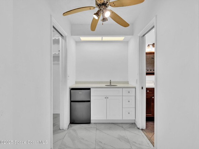 5118 Adams St, Hollywood, FL 33021 - bar featuring freestanding refrigerator, marble finish floor, a ceiling fan, and a sink