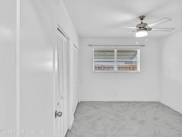 5118 Adams St, Hollywood, FL 33021 - unfurnished bedroom featuring marble finish floors, ceiling fan, multiple closets, and baseboards