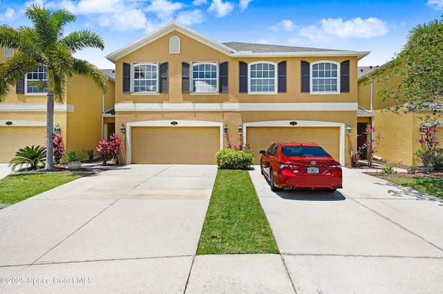 3202 Arden Cir, Melbourne, FL 32934 - view of front of house with a garage, stucco siding, and concrete driveway