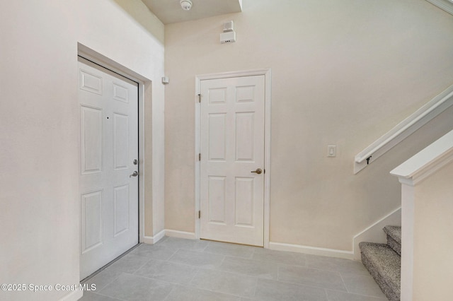 3202 Arden Cir, Melbourne, FL 32934 - entrance foyer with stairway, baseboards, and light tile patterned floors