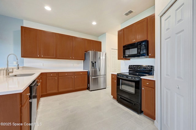 3202 Arden Cir, Melbourne, FL 32934 - kitchen featuring black appliances, a sink, light countertops, brown cabinetry, and recessed lighting