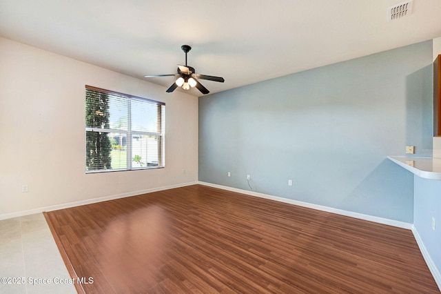 3202 Arden Cir, Melbourne, FL 32934 - spare room featuring ceiling fan, wood finished floors, and baseboards