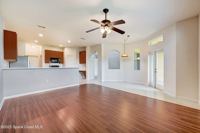 3202 Arden Cir, Melbourne, FL 32934 - unfurnished living room featuring light wood-style flooring, a ceiling fan, recessed lighting, and baseboards