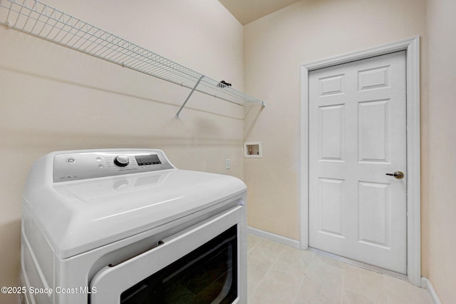 3202 Arden Cir, Melbourne, FL 32934 - washroom with washer / clothes dryer, baseboards, and light tile patterned floors
