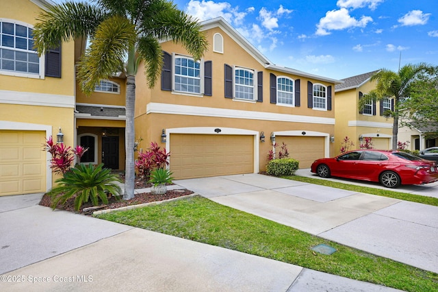 3202 Arden Cir, Melbourne, FL 32934 - townhome / multi-family property featuring stucco siding, a garage, and concrete driveway