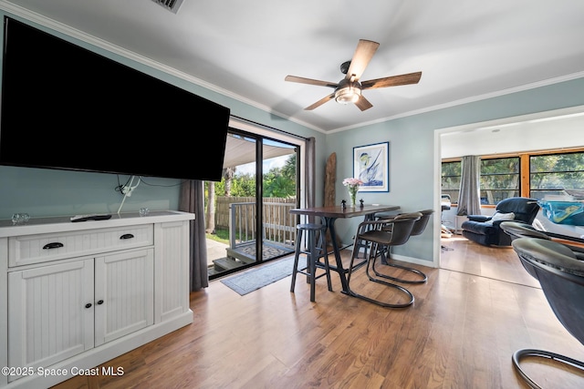 9633 Honeysuckle Dr, Sebastian, FL 32976 - dining room featuring ornamental molding, a wealth of natural light, light wood-style flooring, and ceiling fan