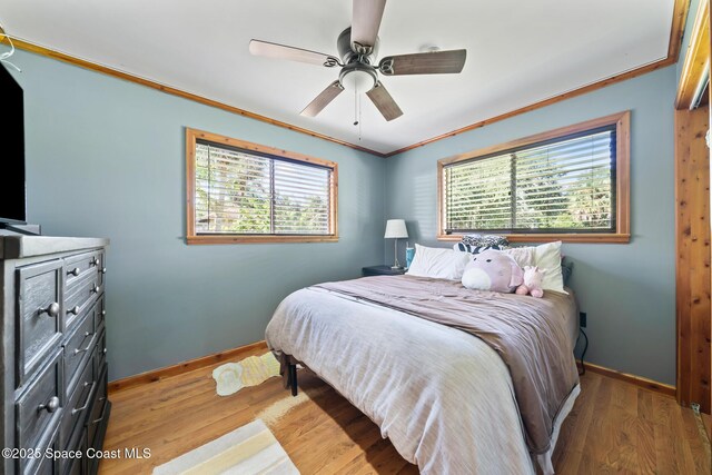 9633 Honeysuckle Dr, Sebastian, FL 32976 - bedroom with ornamental molding, light wood-style flooring, baseboards, and ceiling fan