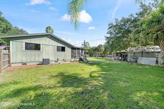 9633 Honeysuckle Dr, Sebastian, FL 32976 - view of yard with fence, a sunroom, and central AC