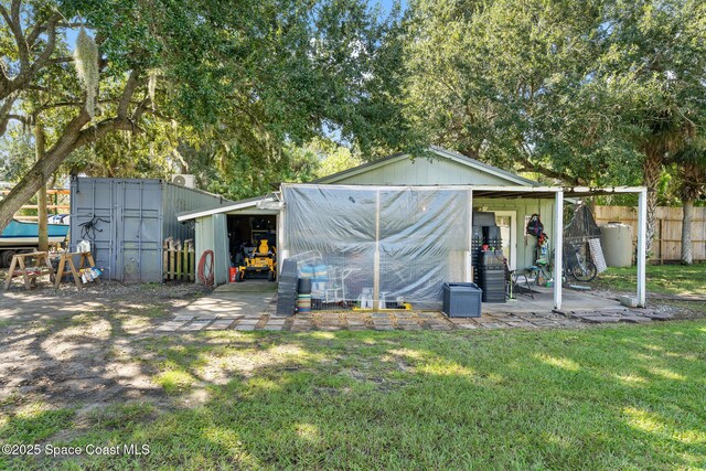 9633 Honeysuckle Dr, Sebastian, FL 32976 - view of outdoor structure featuring an outbuilding and fence