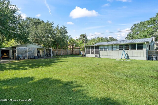 9633 Honeysuckle Dr, Sebastian, FL 32976 - view of yard with a sunroom and fence