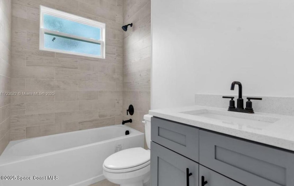 3195 Fitzpatrick Ave, Palm Bay, FL 32908 - full bathroom featuring vanity, toilet, and shower / tub combination