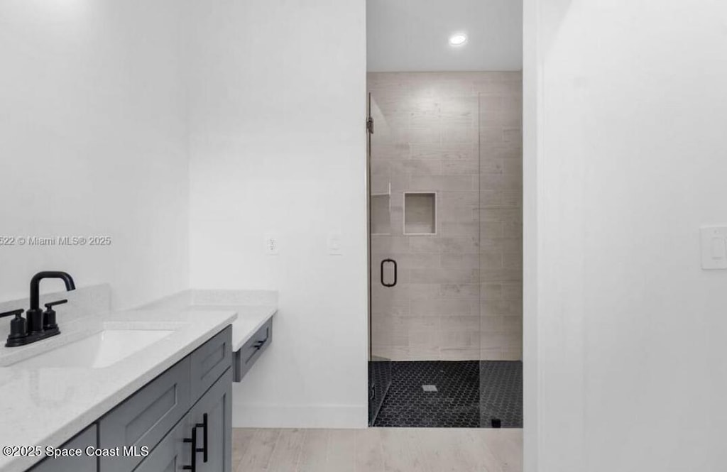 3195 Fitzpatrick Ave, Palm Bay, FL 32908 - bathroom featuring vanity, a shower stall, baseboards, and recessed lighting