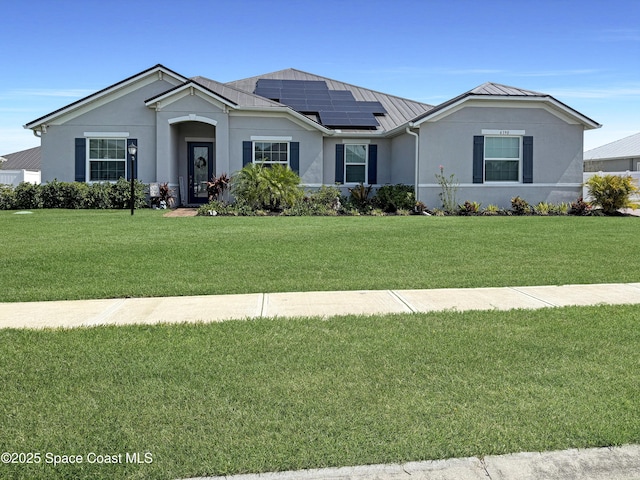 4190 Domain Ct, Melbourne, FL 32934 - ranch-style house featuring a standing seam roof, roof mounted solar panels, a front yard, and metal roof