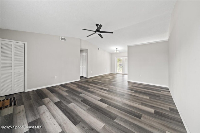 unfurnished living room featuring ceiling fan, wood finished floors, vaulted ceiling, and baseboards