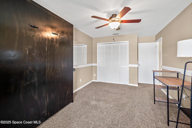 1265 Giralda Cir NW, Palm Bay, FL 32907 - unfurnished bedroom featuring carpet floors, a textured ceiling, baseboards, and a ceiling fan